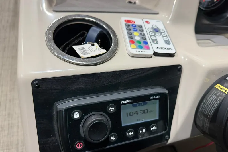 Slide: The Image of Control panel of 2021 Harris Cruiser 210 with remotes and Fusion MS-RA55 radio. - 9