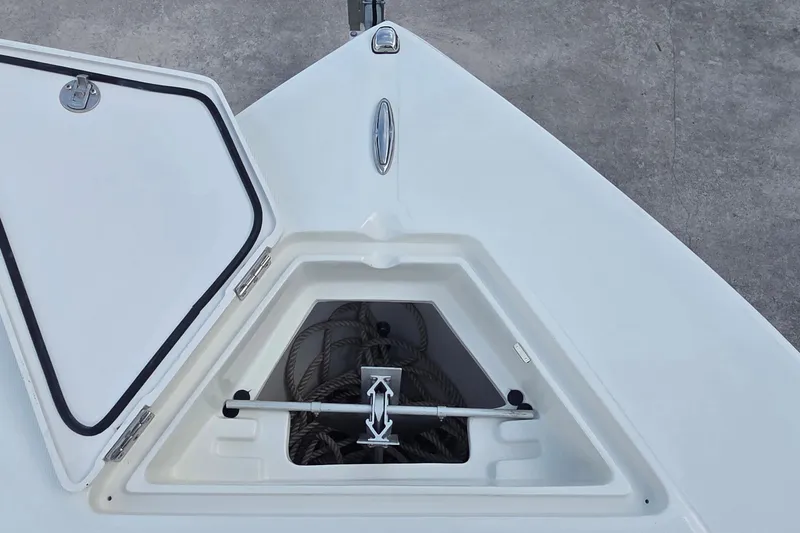 Slide: The Image of Open anchor compartment on 2014 Jupiter 26 FS boat, showing ropes and anchor. - 10
