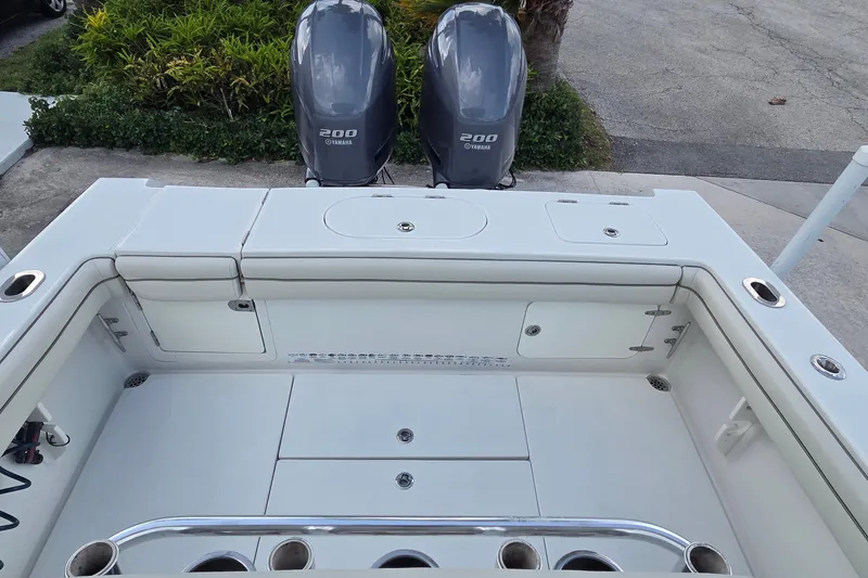 Slide: The Image of 2014 Jupiter 26 FS boat with twin Yamaha 200 engines, featuring spacious deck layout. - 11