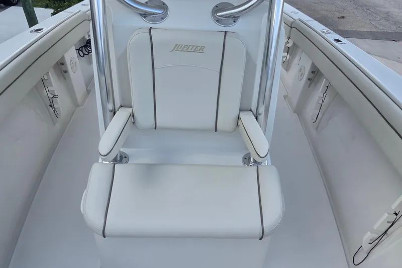 Slide: The Image of 2014 Jupiter 26 FS boat seat with white upholstery and armrests. - 14