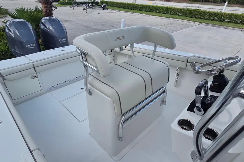 Slide: The Image of 2014 Jupiter 26 FS boat interior with dual Yamaha 200 engines and helm station. - 16
