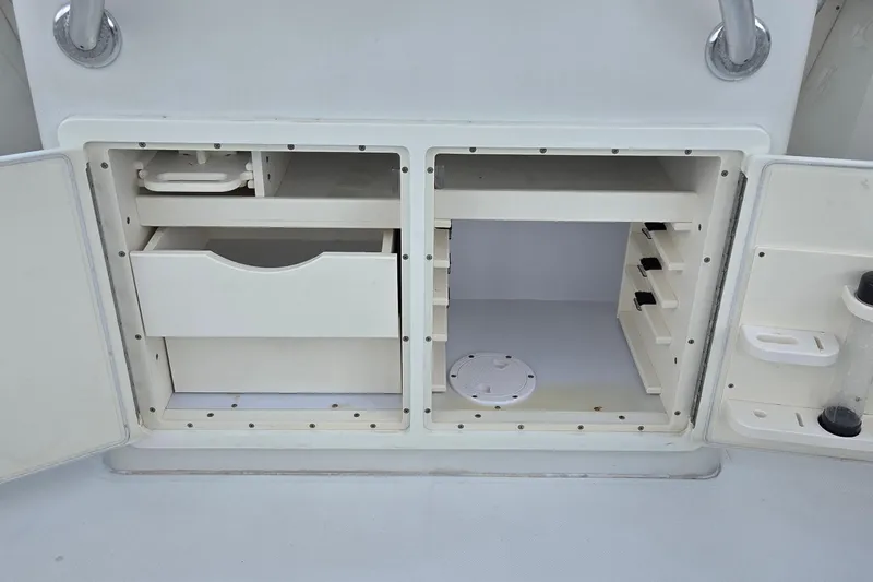 Slide: The Image of Open storage compartments on a 2014 Jupiter 26 FS boat. - 17