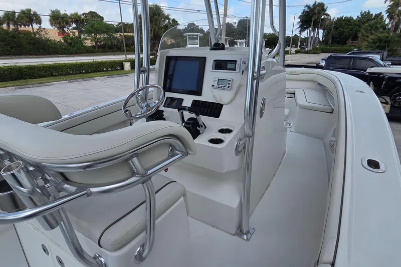 Slide: The Image of 2014 Jupiter 26 FS boat cockpit with steering wheel and navigation equipment. - 22