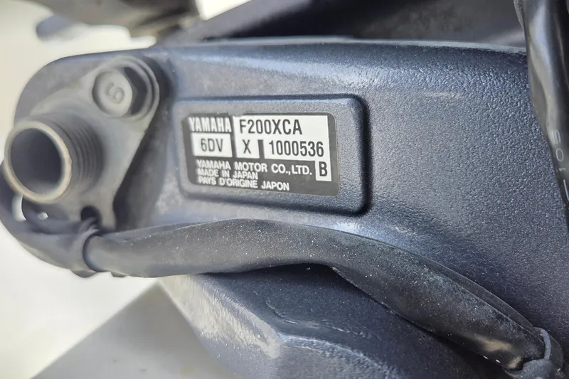 Slide: The Image of Close-up of Yamaha F200XCA engine label on a 2014 Jupiter 26 FS boat. - 25