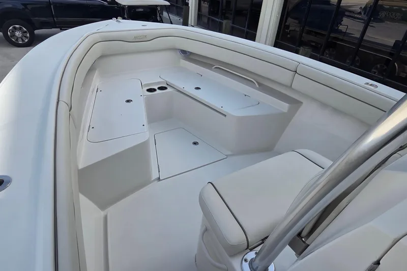 Slide: The Image of 2014 Jupiter 26 FS boat interior with white seating and storage compartments. - 3