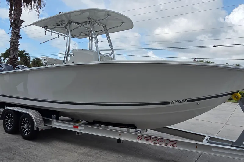 Slide: The Image of 2014 Jupiter 26 FS boat on trailer under cloudy sky. - 4
