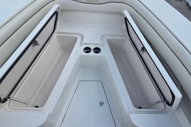 Slide: The Image of 2014 Jupiter 26 FS boat interior with open storage compartments and cup holders. - 9