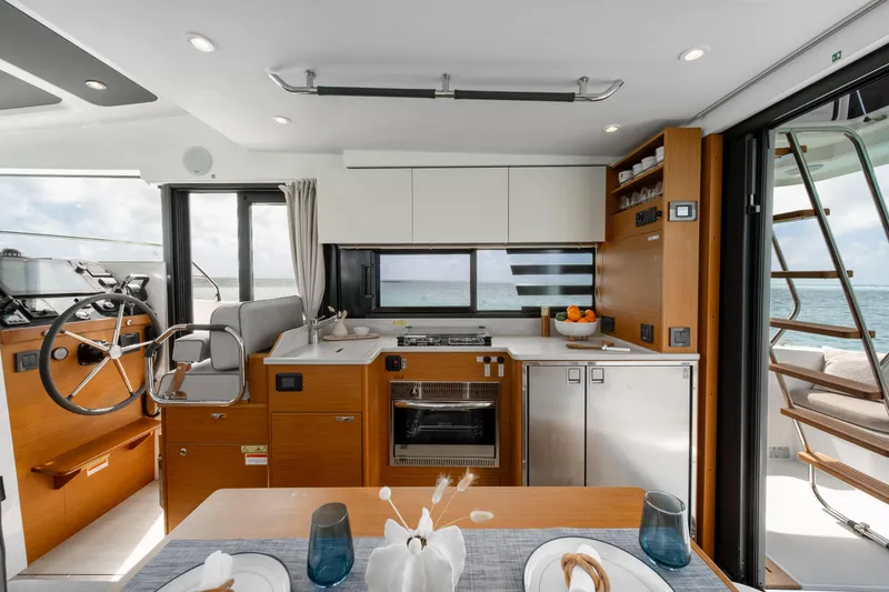 Slide: The Image of Interior of 2026 Beneteau Swift Trawler 37 Fly, featuring modern kitchen and helm. - 12