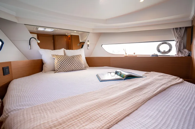 Slide: The Image of Luxurious cabin interior of 2026 Beneteau Swift Trawler 37 Fly with cozy bedding. - 13