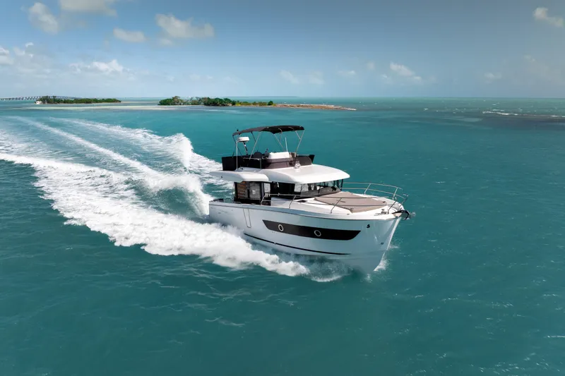 Slide: The Image of 2026 Beneteau Swift Trawler 37 Fly cruising on turquoise waters near an island. - 19