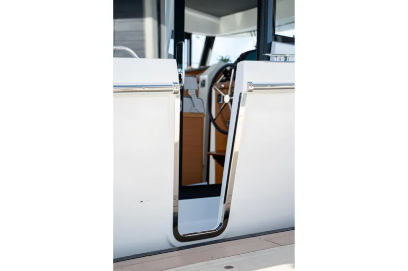 Slide: The Image of 2026 Beneteau Swift Trawler 37 Fly, helm view through open door. - 23