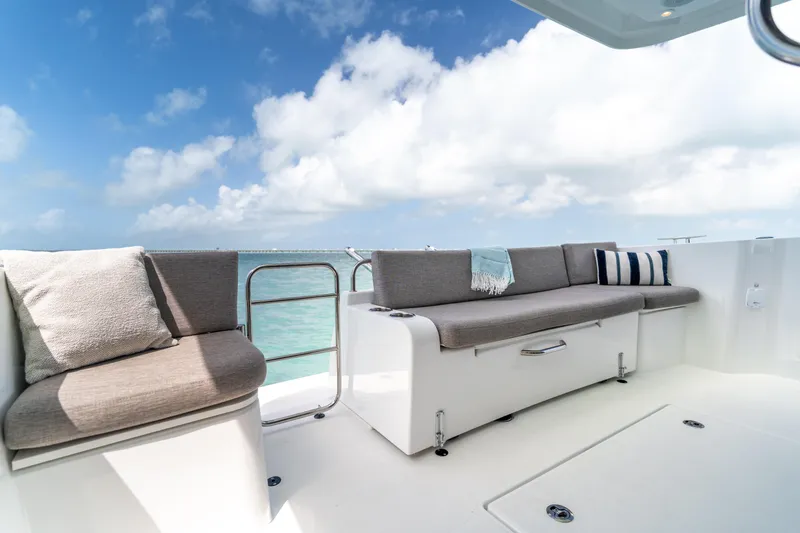 Slide: The Image of Luxurious seating area on 2026 Beneteau Swift Trawler 37 Fly, under clear blue skies. - 26