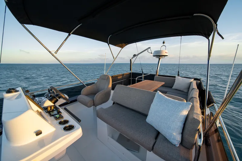 Slide: The Image of Flybridge of 2026 Beneteau Swift Trawler 37, featuring seating and ocean view. - 27
