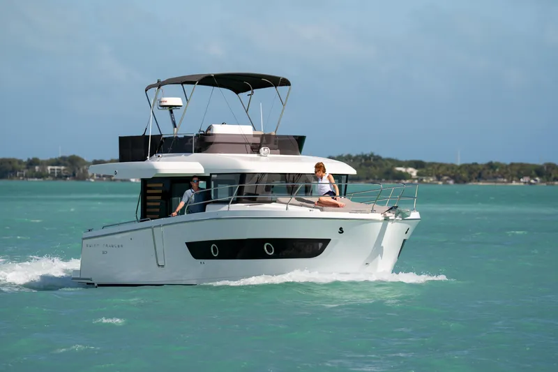 Slide: The Image of 2026 Beneteau Swift Trawler 37 Fly cruising on turquoise waters. - 3
