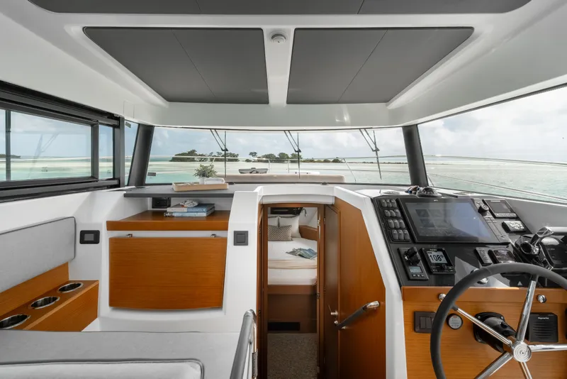Slide: The Image of Interior of 2026 Beneteau Swift Trawler 37 Fly, featuring helm and cabin view. - 9