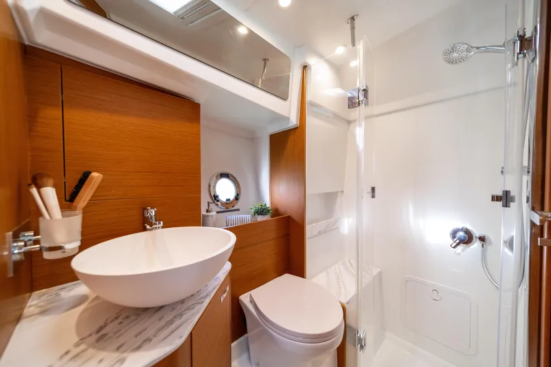 Slide: The Image of Luxurious bathroom in 2026 Beneteau Swift Trawler 37 Fly yacht, featuring modern fixtures and wood accents. - 14