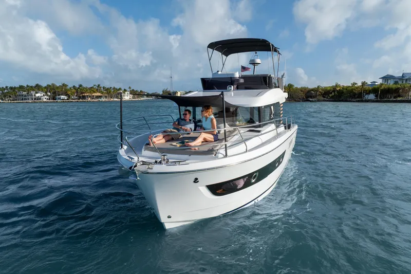 Slide: The Image of 2026 Beneteau Swift Trawler 37 Fly cruising on turquoise waters near an island. - 18