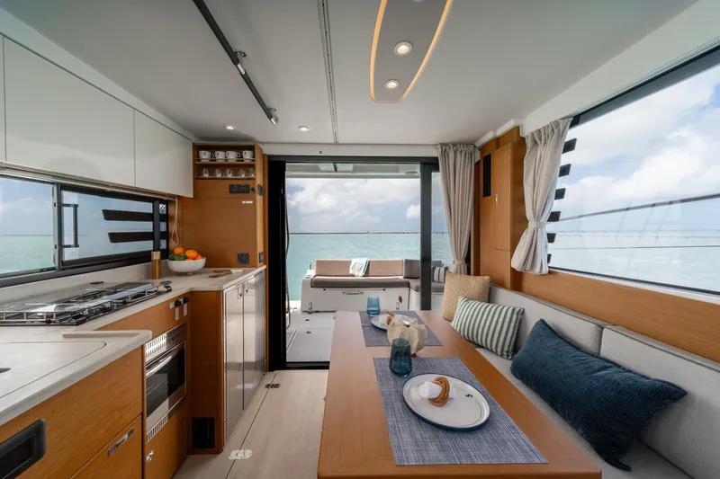Slide: The Image of 2026 Beneteau Swift Trawler 37 Fly cruising in turquoise waters near an island. - 3