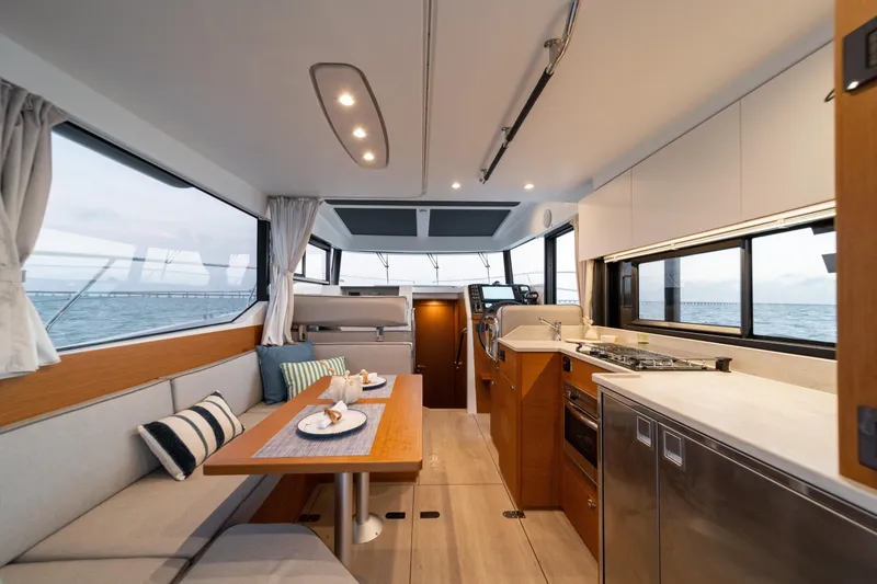 Slide: The Image of Interior of 2026 Beneteau Swift Trawler 37 Fly with people enjoying the cabin. - 5