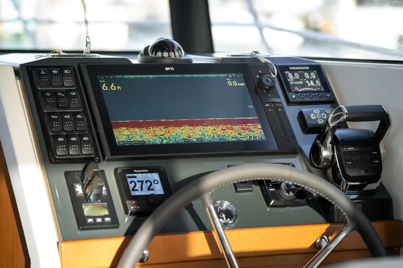 Slide: The Image of Interior of 2026 Beneteau Swift Trawler 37 Fly, featuring helm and cabin view. - 8