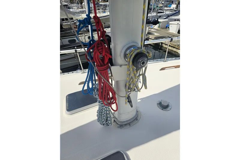 Slide: The Image of 1987 Morgan Classic 41 Center Cockpit sailboat mast with colorful ropes and winch. - 10