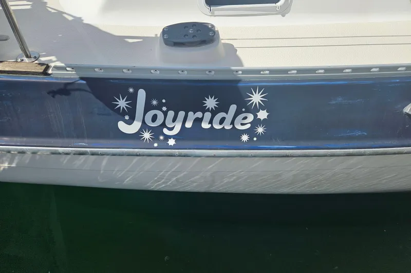 Slide: The Image of 1987 Morgan Classic 41 Center Cockpit sailboat named "Joyride" with decorative lettering. - 13