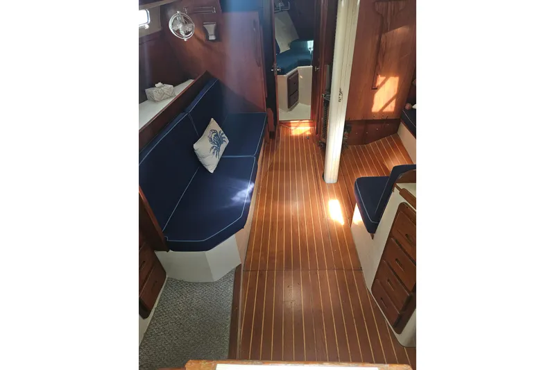 Slide: The Image of Interior of 1987 Morgan Classic 41 Center Cockpit with wooden flooring and blue seating. - 14