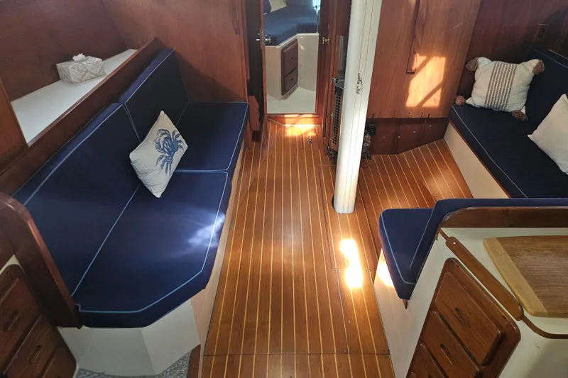 Slide: The Image of Interior of 1987 Morgan Classic 41 Center Cockpit with wooden flooring and blue seating. - 15