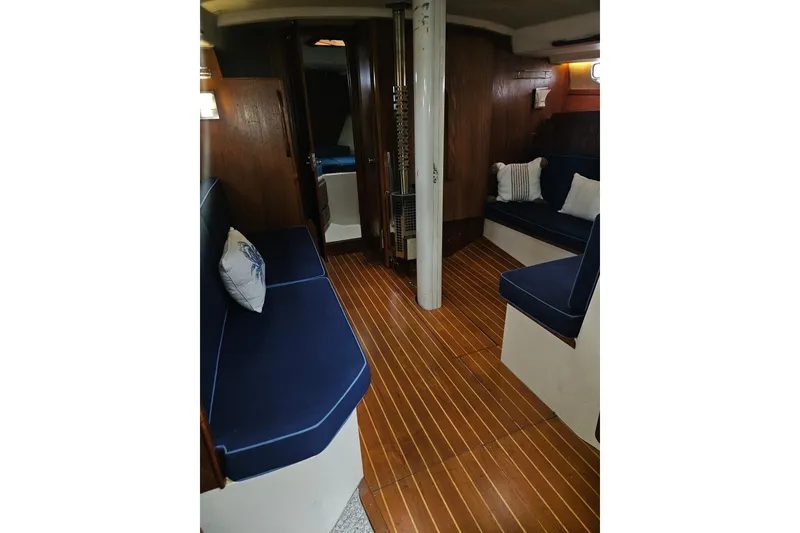 Slide: The Image of Interior of 1987 Morgan Classic 41 Center Cockpit with wooden flooring and blue seating. - 16