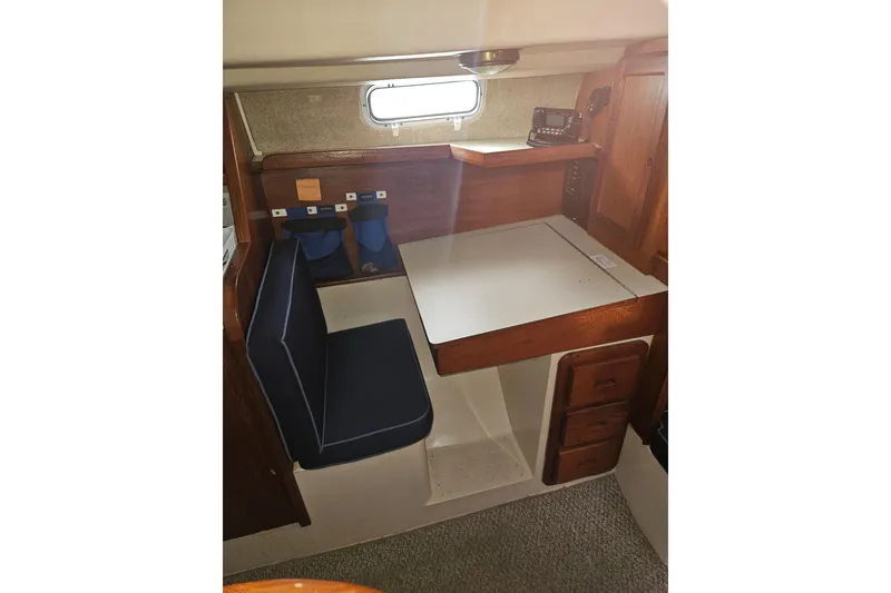 Slide: The Image of 1987 Morgan Classic 41 Center Cockpit interior with navigation station and seating. - 17