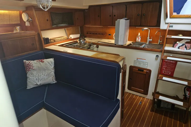 Slide: The Image of Interior of 1987 Morgan Classic 41 Center Cockpit with kitchen and seating area. - 22
