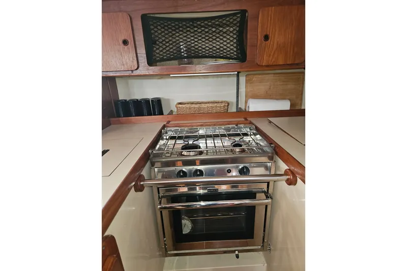 Slide: The Image of Galley kitchen in 1987 Morgan Classic 41 Center Cockpit yacht with stove and storage. - 24