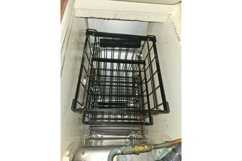 Slide: The Image of Storage compartment with black wire basket in 1987 Morgan Classic 41 Center Cockpit. - 27