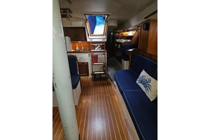 Slide: The Image of Interior of 1987 Morgan Classic 41 Center Cockpit with wooden flooring and blue seating. - 29
