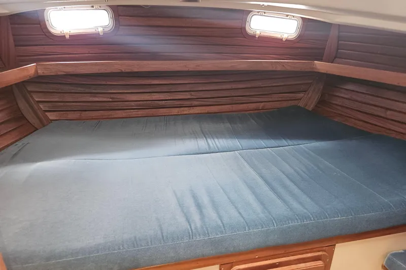 Slide: The Image of Interior cabin of 1987 Morgan Classic 41 Center Cockpit with wooden paneling and blue mattress. - 30