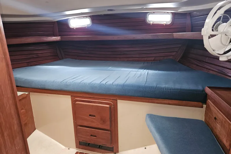 Slide: The Image of Interior cabin of 1987 Morgan Classic 41 Center Cockpit with wooden finish and blue bedding. - 31