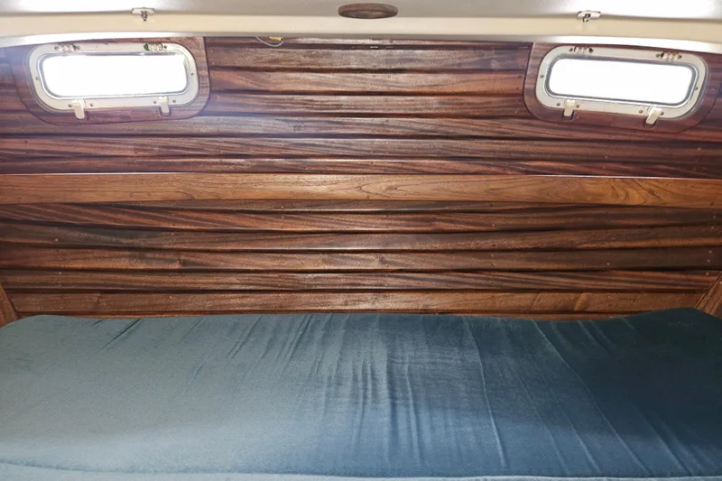 Slide: The Image of Interior of 1987 Morgan Classic 41 Center Cockpit with wooden paneling and portholes. - 32