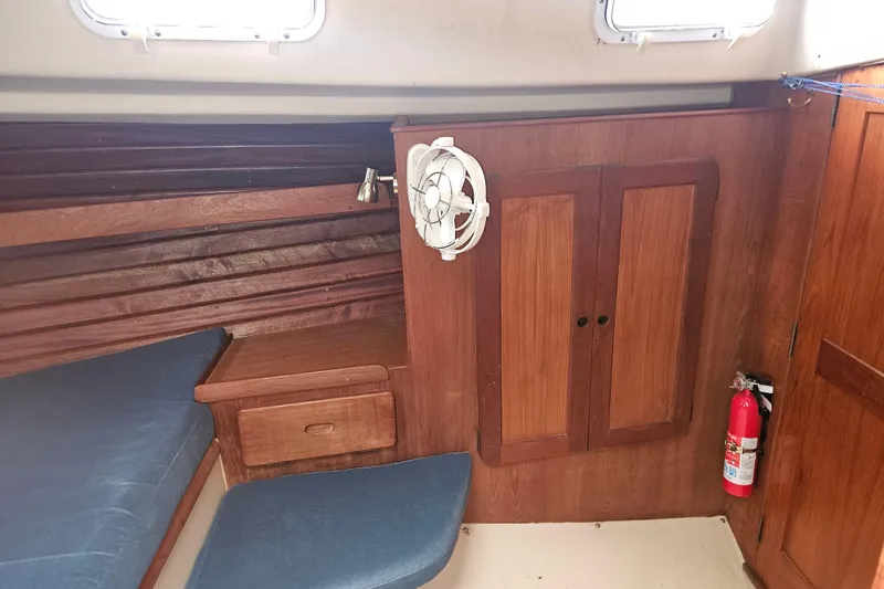 Slide: The Image of 1987 Morgan Classic 41 Center Cockpit interior with wooden cabinetry and blue cushions. - 34