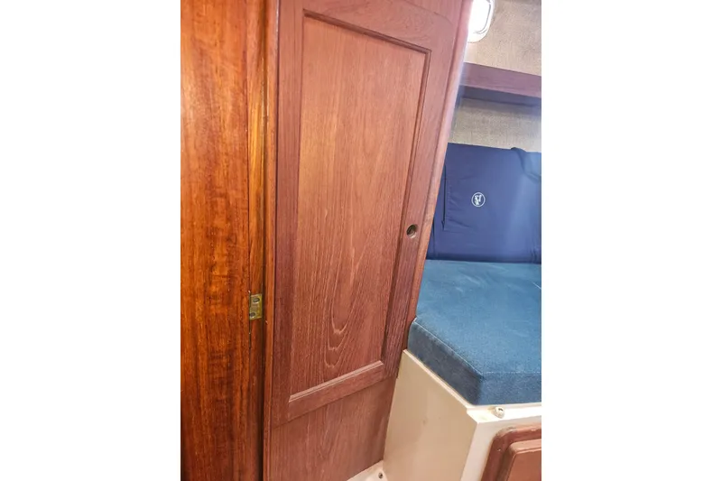 Slide: The Image of 1987 Morgan Classic 41 Center Cockpit interior with wooden door and blue cushioned seating. - 35