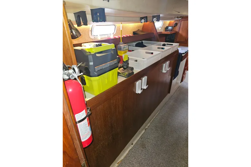 Slide: The Image of 1987 Morgan Classic 41 Center Cockpit interior with storage and fire extinguisher. - 36