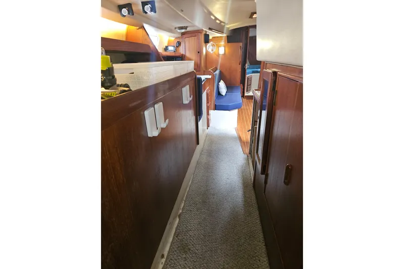 Slide: The Image of Interior of 1987 Morgan Classic 41 Center Cockpit yacht with wooden cabinetry and blue seating. - 37