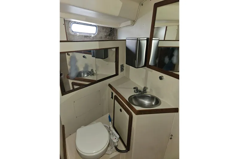 Slide: The Image of 1987 Morgan Classic 41 Center Cockpit bathroom with sink, toilet, and mirror. - 41