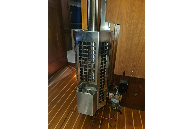 Slide: The Image of 1987 Morgan Classic 41 Center Cockpit interior with metal heater on wooden floor. - 45