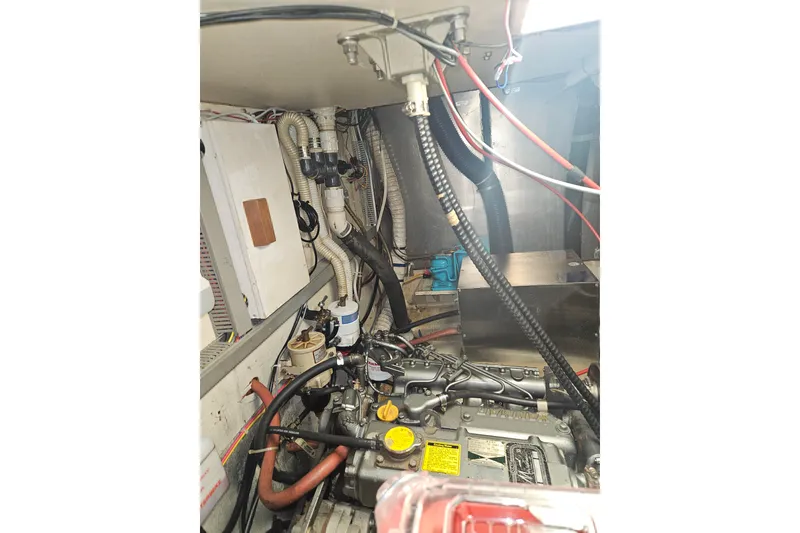 Slide: The Image of Engine room of 1987 Morgan Classic 41 Center Cockpit sailboat, showcasing mechanical components. - 52