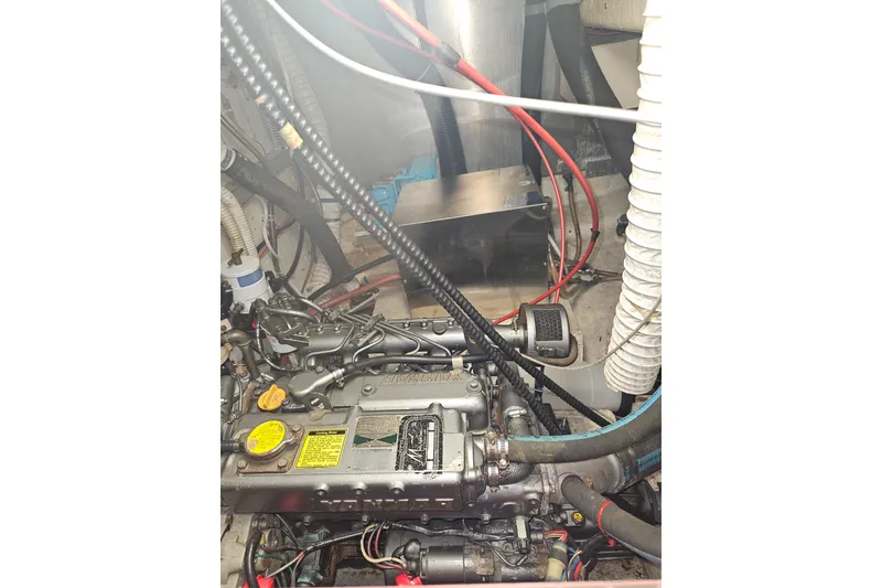 Slide: The Image of Engine compartment of a 1987 Morgan Classic 41 Center Cockpit sailboat, showing detailed components. - 53