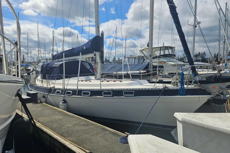 Slide: The Image of 1987 Morgan Classic 41 Center Cockpit sailboat docked at marina under cloudy sky. - 57