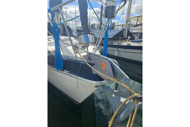 Slide: The Image of 1987 Morgan Classic 41 Center Cockpit sailboat docked, featuring anchor and blue ropes. - 58