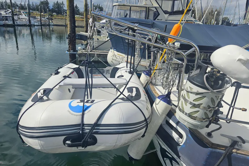 Slide: The Image of 1987 Morgan Classic 41 Center Cockpit with inflatable dinghy at marina. - 60