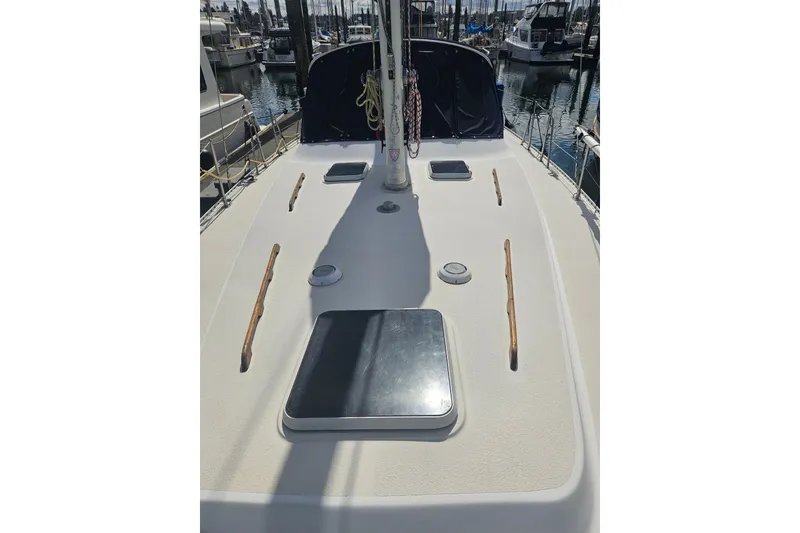 Slide: The Image of 1987 Morgan Classic 41 Center Cockpit sailboat deck with hatches, docked in marina. - 8