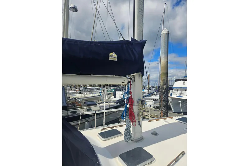 Slide: The Image of 1987 Morgan Classic 41 Center Cockpit sailboat docked at marina, featuring mast and rigging. - 9